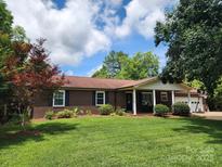 Charming brick home with a well-manicured lawn and a covered front porch, perfect for enjoying the outdoors at 3447 Filbert Hwy, Clover, SC 29710