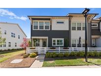 Charming townhome featuring a manicured lawn, white picket fence and a blend of modern and traditional design elements at 5481 Comiskey Aly, Kannapolis, NC 28081