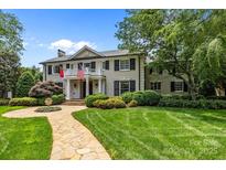 Charming two-story home featuring manicured landscaping and a stone walkway leading to the front entrance at 640 Colville Rd, Charlotte, NC 28207