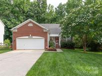 Charming brick home with a well-manicured lawn and a welcoming front entrance at 9348 Golden Pond Dr, Charlotte, NC 28269