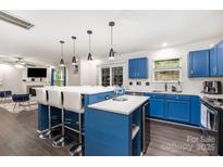 Bright kitchen features blue cabinets, white countertops, and stainless steel appliances at 9524 Eagle Feathers Dr, Charlotte, NC 28214