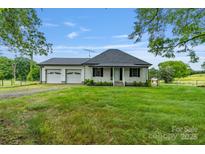 Charming single-story home featuring an attached two-car garage and a covered front porch at 956 Stony Point Rd, Kings Mountain, NC 28086