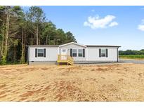 Inviting home with a classic design, featuring a well-manicured lawn at 977 Myers Mill Rd, Olin, NC 28660