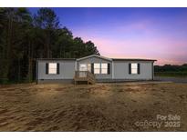 Charming single-story home with gray siding and a welcoming front porch at 977 Myers Mill Rd, Olin, NC 28660
