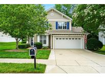 Charming two-story home with a well-maintained lawn, a two-car garage, and blue shutters at 147 Whitley Mills Rd, Fort Mill, SC 29708