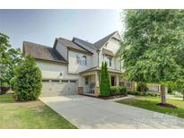 Charming two-story home with a well-manicured lawn and a spacious driveway leading to a two-car garage at 15344 Cimarron Hills Ln, Charlotte, NC 28278