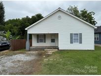 Charming single-story home with white siding, gray shutters, and a small front porch at 303 Southern Ave, East Spencer, NC 28039