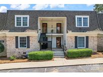 Charming townhome featuring classic brick facade, covered balconies, and well-manicured landscaping at 3520 Colony Rd # D, Charlotte, NC 28211