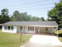 Charming single-story home featuring a covered carport and well-manicured front yard at 8095 New St, Mount Pleasant, NC 28124