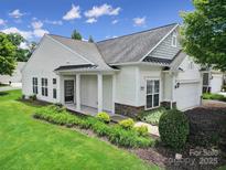 Charming single-story home featuring a manicured lawn, tasteful landscaping, and inviting front entrance at 9020 Smokey Hill Ln, Fort Mill, SC 29707