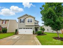 Charming two-story home featuring a two-car garage, well-maintained lawn, and lovely landscaping at 9733 Paper Tree Rd, Charlotte, NC 28227