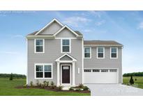 Charming two-story home with gray siding, a neatly manicured lawn, and an attached two-car garage at 12013 Beaux Art Ln, Charlotte, NC 28214