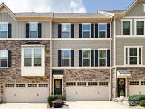 Charming townhouse featuring stone accents, a welcoming entrance, and attached garages at 1839 Shumard Ln, Charlotte, NC 28205