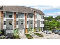 View of newly constructed townhomes featuring modern architecture, individual garages, and colorful front doors at 2653 Shenandoah Ave, Charlotte, NC 28205