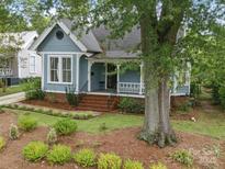Charming blue home with a landscaped front yard and a cozy front porch at 308 W Monroe St, Salisbury, NC 28144