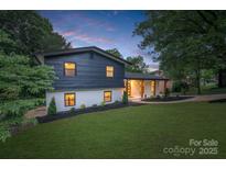 Charming two-story home with a landscaped yard and a freshly painted black and white exterior at 3326 Winterfield Pl, Charlotte, NC 28205