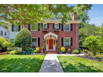 Charming two-story brick home with a red door and meticulously landscaped front yard at 361 5Th Nw St, Hickory, NC 28601