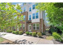 Modern townhome with brick facade, white accents, tidy landscaping, and visible balcony at 420 E 16Th St, Charlotte, NC 28206