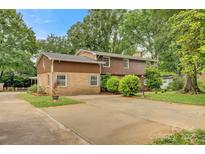 Inviting two-story home with brick and wood panel exterior and an extended driveway at 841 12Th Nw Ave, Hickory, NC 28601