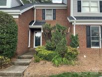 Charming brick home with a welcoming front entrance and beautifully landscaped garden in a well-kept neighborhood at 9121 Kings Canyon Dr, Charlotte, NC 28210
