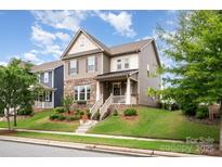 Charming two-story home with landscaped yard and inviting front porch at 915 Claires Creek Ln, Davidson, NC 28036
