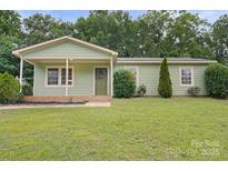 Charming single-story home with a well-manicured lawn and welcoming front porch at 918 Creekridge Dr, Monroe, NC 28110