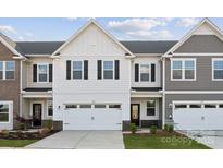 Charming two-story townhome with white siding, black shutters, and a two-car garage at 1213 Margo Mannor Dr, Fort Mill, SC 29708