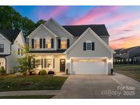 Charming two-story home with a well-manicured lawn and a two-car garage, perfect for Gathering living at 1543 Ab Moore Jr Dr, Indian Trail, NC 28079