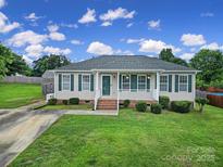 Charming single-story home features a well-manicured lawn and inviting front porch at 1744 Marsley Ln, Rock Hill, SC 29730
