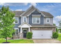 Charming two-story home with a two-car garage, stone accents, and well-maintained landscaping at 198 Wrangell Dr, Mooresville, NC 28117
