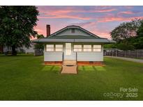 Charming home with a manicured lawn and picturesque sunset backdrop at 3345 Long Ferry Rd, Salisbury, NC 28146