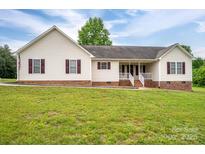 Charming single-Gathering home featuring vinyl siding, red brick foundation, and a well-maintained front lawn at 5129 Whitetail Ct, Crouse, NC 28033