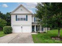 Charming two-story home with a well-maintained lawn and a two-car garage at 5741 Bentgrass Run Dr, Charlotte, NC 28269