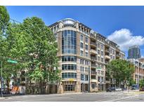 Modern condominium building showcasing large windows, balconies, and a street-level Subway restaurant at 718 W Trade St # 105, Charlotte, NC 28202
