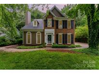 Charming brick home with black shutters and lush green lawn at 8624 Canter Post Dr, Charlotte, NC 28216