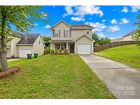 Charming two-story home featuring a well-maintained lawn, attached garage, and inviting front porch area at 1023 Valley Ridge Rd, Charlotte, NC 28214