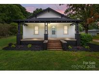 Charming home featuring a cozy front porch with updated landscaping at 1406 Upper Enochville Rd, Kannapolis, NC 28081