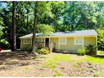 Charming single-story home with a welcoming front porch and lush green surroundings at 1583 Green Circle Dr, Gastonia, NC 28054