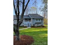 Charming single-story home with gray brick and siding, complemented by a well-manicured lawn and tree at 205 Wellington Hills Cir # 205, Salisbury, NC 28147