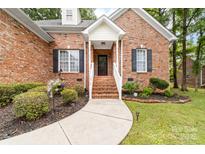 Charming brick home with a covered front porch and well-manicured landscaping at 212 Victoria Cir, York, SC 29745