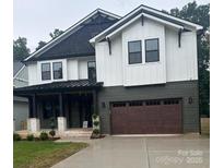 Beautiful new construction with a two car garage and stylish dark trim at 2412 Kingsbury Dr, Charlotte, NC 28205