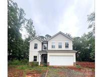 Charming two-story home features a large garage and classic architectural details, nestled amid lush trees at 3248 Killian Rd, Lincolnton, NC 28092