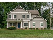 Charming two-story home with a well-manicured lawn and inviting blue front door at 360 Sundown Rd, Mooresville, NC 28117