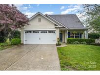 Charming single-Gathering home with a white garage door, manicured lawn, and inviting curb appeal at 5927 Leawood Run Ct, Charlotte, NC 28269