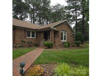 Charming brick home with a well-manicured lawn and a brick walkway leading to the front door at 600 Colby Cir, Salisbury, NC 28147