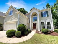 Traditional two-story home featuring manicured landscaping and inviting entryway with a covered porch at 6413 Fillian Ln, Charlotte, NC 28269