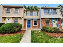 Charming townhome showcasing a bright blue front door and colorful window shutters at 7609 Holly Grove Ct, Charlotte, NC 28227