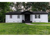 Charming brick home featuring a cozy front porch and a well-manicured lawn at 901 Echo Glen Rd, Charlotte, NC 28213
