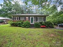 Charming single-story home with a well-maintained front yard, framed by mature trees providing ample shade at 1004 E 8Th Ave, Gastonia, NC 28054