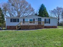 Charming single story home featuring a brick foundation and inviting front porch at 1038 Gold Mine Dr, Catawba, NC 28609
